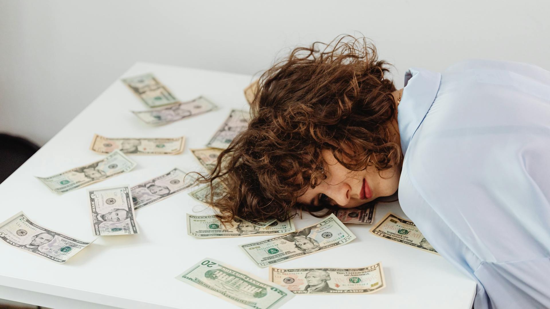Person checking bank balance on phone at night — money anxiety